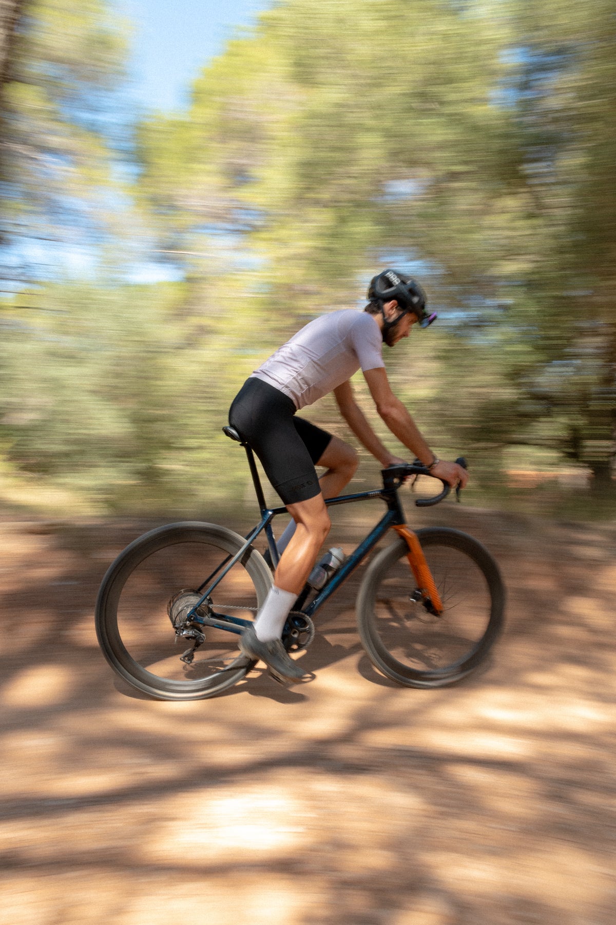 Cyclist wearing Vairok glasses with her road bike on a mountain road
